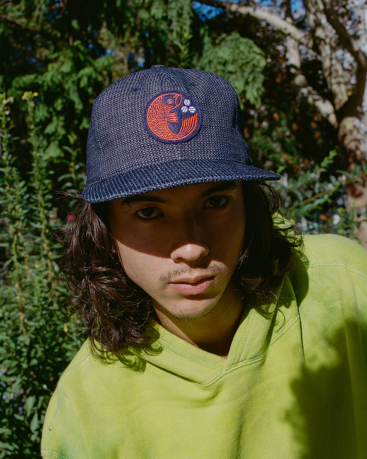 Ebbets Field Hiroshima Carp Japanese Indigo Cotton Dobby Ballcap featuring an indigo-dyed, textured baseball cap with a circular patch and an orange Hiroshima Carp design.