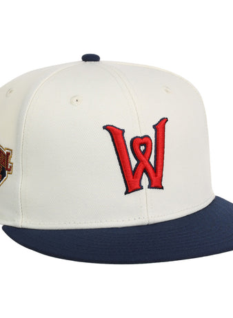 The Ebbets Field Worcester Red Sox MiLB Snapback Ballcap is a white cap with a navy blue brim, red W logo on the front, and a commemorative patch on the left side.
