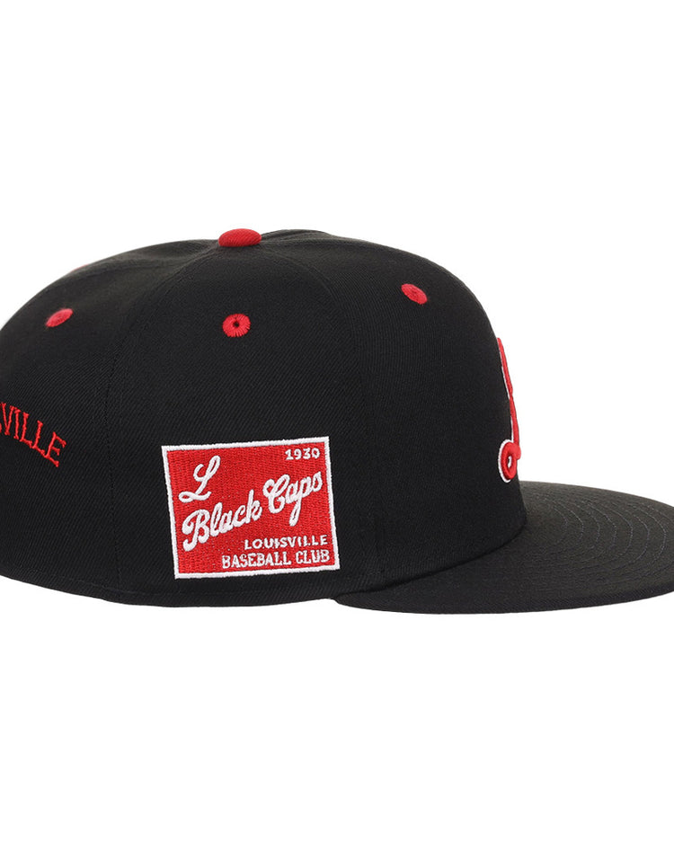 The Ebbets Field Louisville Black Caps NLB Varsity Fitted Ballcap is a black cap with red accents, a red and white “L Black Caps Louisville Baseball Club” patch on the side, and “LOUISVILLE” embroidered in red on the back.