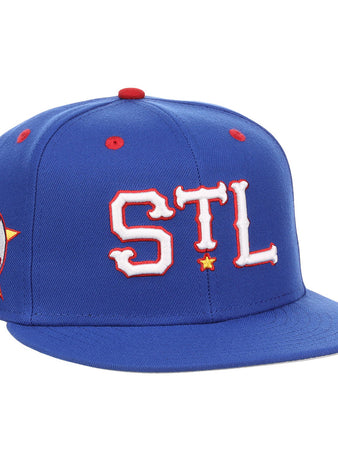 The Ebbets Field St. Louis Stars NLB Varsity Fitted Ballcap features a royal blue design, “STL” in bold white and red on the front, a side “St. Louis” patch, red accents, and a flat brim.