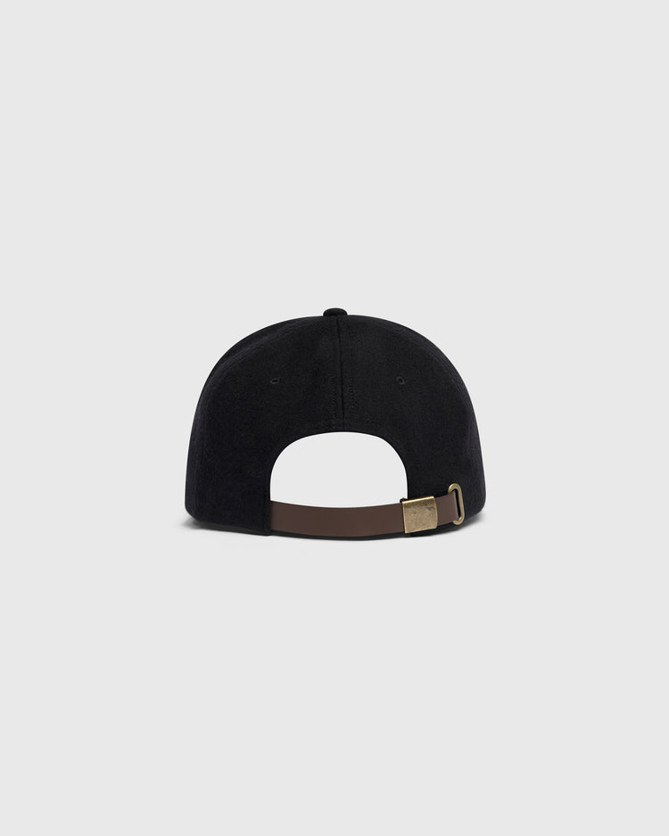Rear view of a black wool Mystery Caps of Mexico – Agrario de México 1935 Wool Ballcap, featuring an adjustable brown strap with a gold-tone metal buckle.