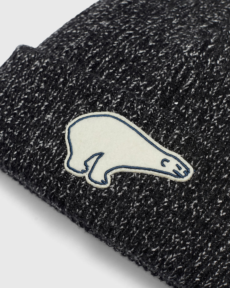 Cerveceria Polar Bear Felt Patch Ribbed Beanie in black and white rib-knit, featuring a white felt patch of a bear outlined in blue.