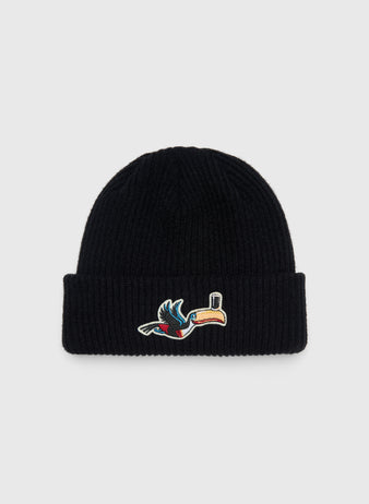 Black rib-knit Guinness Flying Toucan Felt Patch Ribbed Beanie featuring a felt patch of a toucan balancing a glass on its beak.