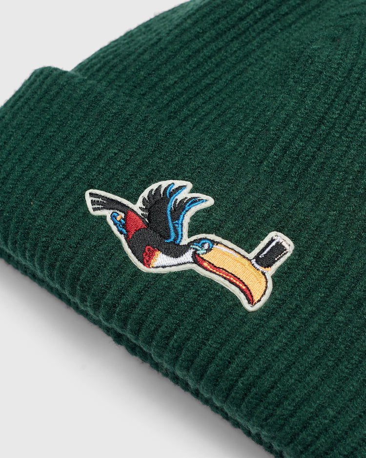Dark green Guinness Flying Toucan Felt Patch Ribbed Beanie featuring a felt patch of a toucan in flight balancing a glass of stout on its beak.