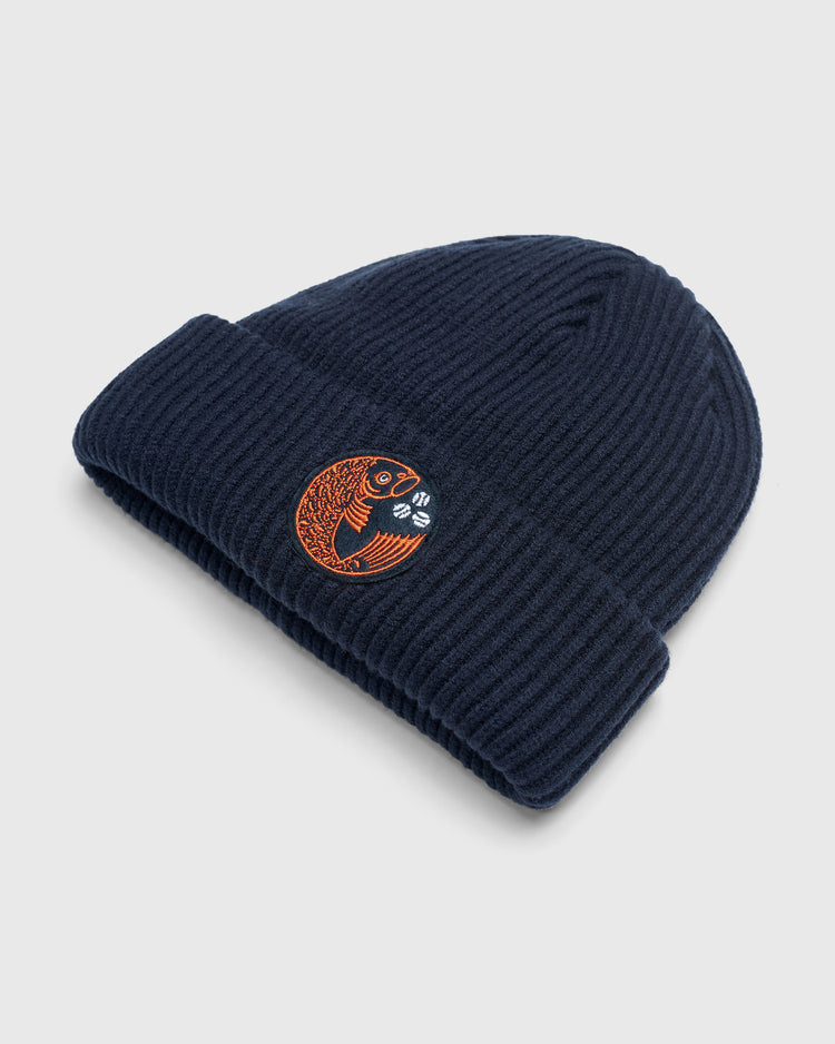 Navy blue rib-knit Hiroshima Carp Felt Patch Ribbed Beanie featuring a circular felt patch with an orange Hiroshima Carp fish and two baseballs.
