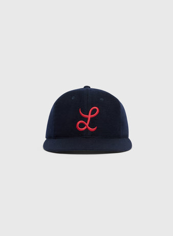 Ebbets Field Mystery Caps of Mexico – La Junta de Nuevo Laredo 1940 Wool Ballcap featuring a navy blue wool design with a red embroidered cursive L on the front.