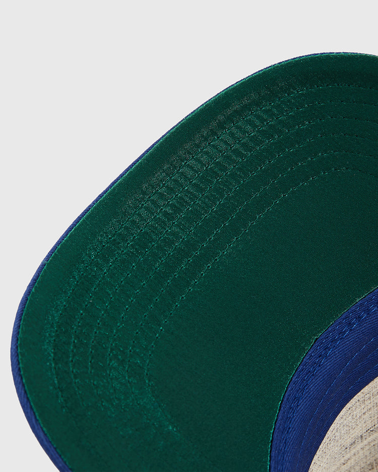 Close-up of the underside of an Ebbets Field Pennsylvania Stoners A-Frame Cotton Twill Ballcap, highlighting the green and blue brim, stitching details, and partial inner lining.