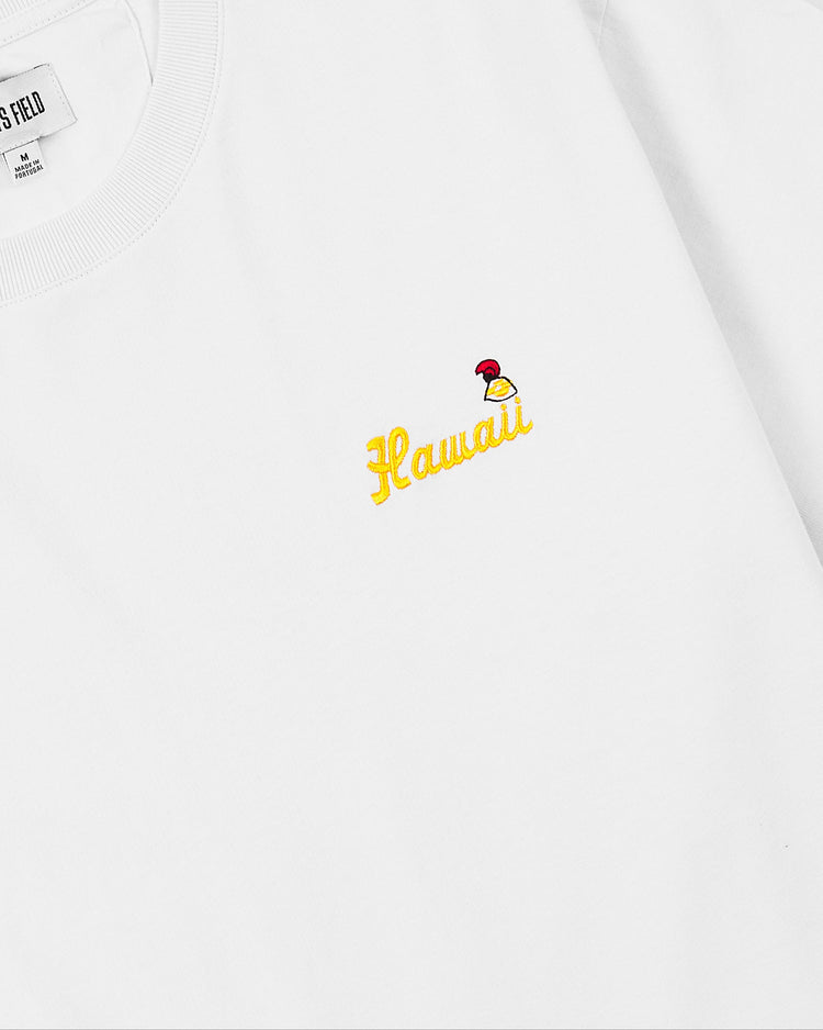 The Ebbets Field Hawaii Islanders (PCL) Graphic Short Sleeve Tee is a white shirt featuring Hawaii embroidered in yellow on the chest, with a small red, yellow, and white bird design next to the text.