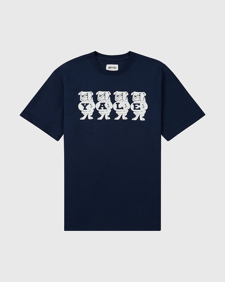 The Ebbets Field YALE SS TEE NAVY features five cartoon bulldogs holding letters to spell YALE in white across the chest. The navy blue shirt is displayed flat on a light background.
