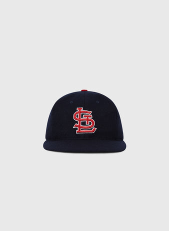 The Ebbets Field St. Louis Cardinals 1963 MLB Authentic Wool Ballcap, from the Decade of Change Collection, features a navy design with a red and white interlocking STL logo, inspired by the original 1963 on-field cap. Displayed on a light gray background.