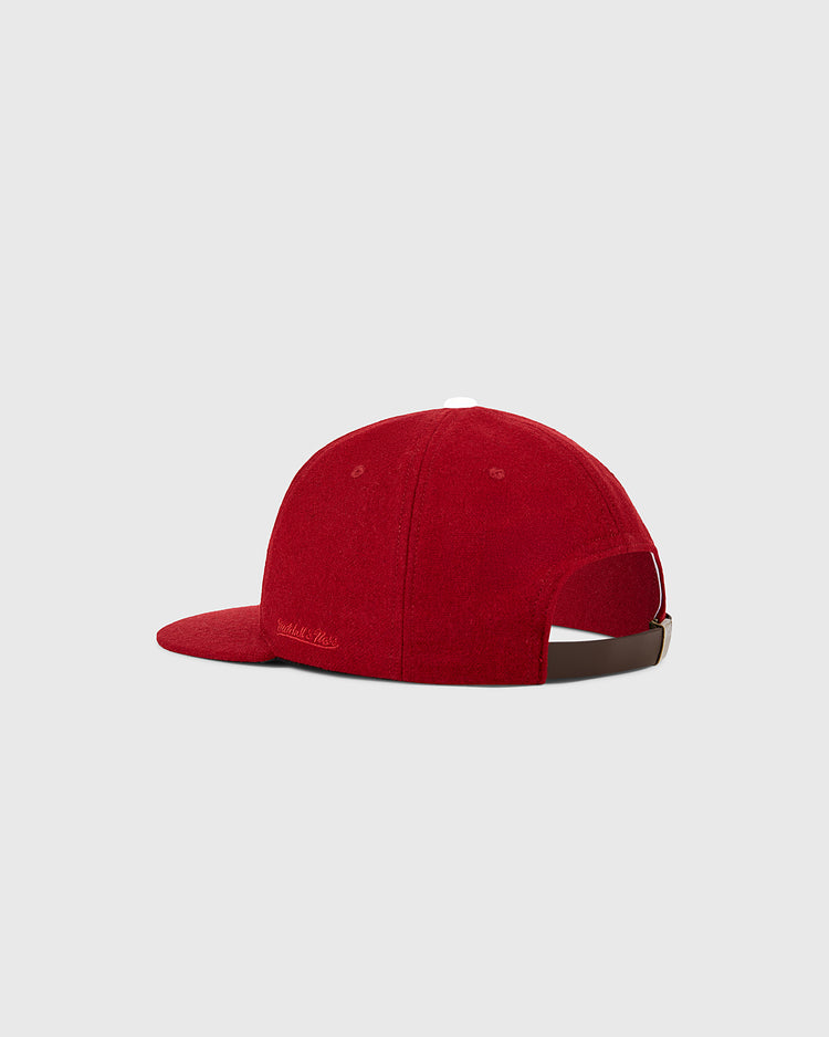 The Ebbets Field Philadelphia Phillies 1964 MLB Authentic Wool Ballcap is a red cap shown from the back, with an adjustable brown strap and white top button, set against a plain light gray background.