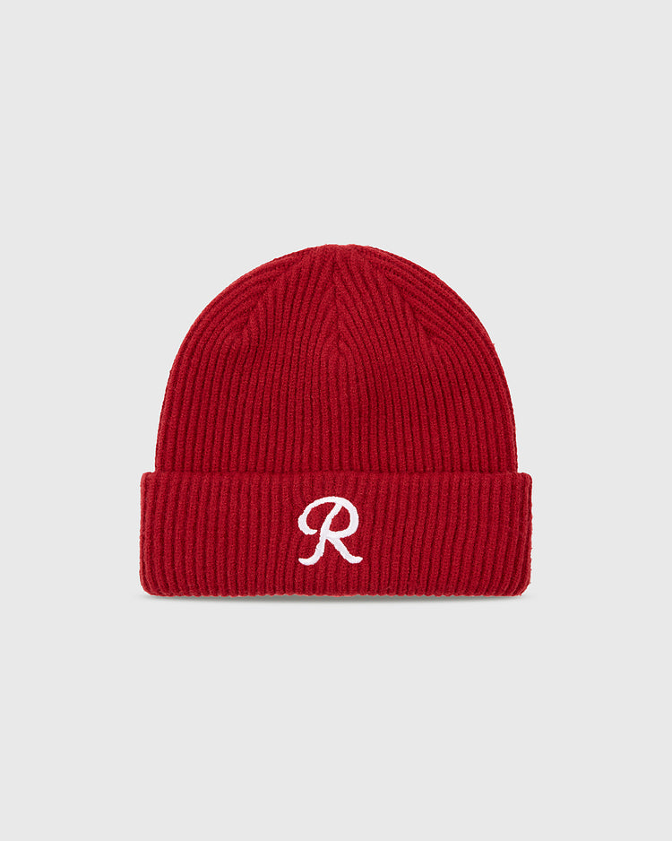 The Seattle Rainiers Embroidered Logo Ribbed Beanie by Ebbets Field features a red knit design with a folded brim and a white embroidered 