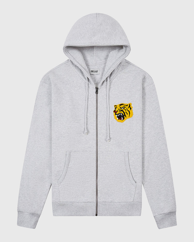 The Ebbets Field Osaka Tigers Heavyweight Cotton Terry Full-Zip Hoodie features a light gray vintage style, front pockets, hood with adjustable drawstrings, and a bold yellow tiger head graphic on the left chest for retro flair.