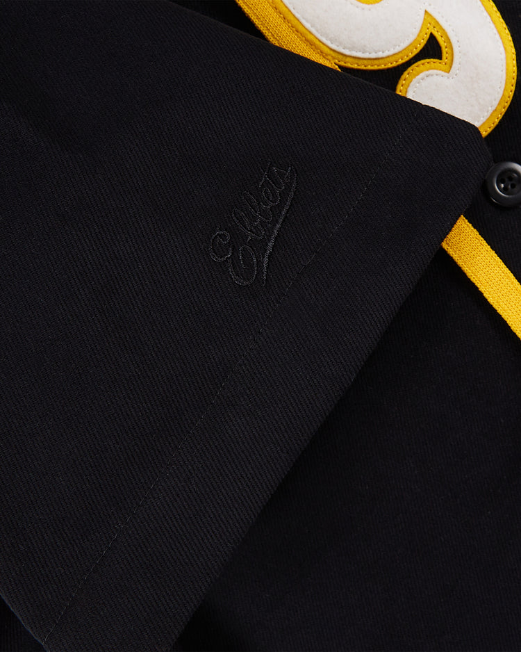 Close-up of the Osaka Tigers Cotton Twill Baseball Jersey by Ebbets Field: black cotton twill with yellow trim, subtle black 
