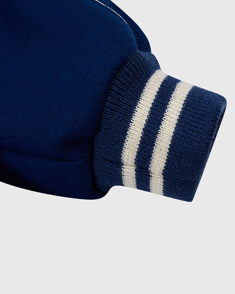 Close-up of the EFF Jackie Robinson All Stars 1953 Authentic Jacket sleeve in navy wool, showing a ribbed cuff with two white stripes, inspired by the Brooklyn Dodgers, set against a plain light background.