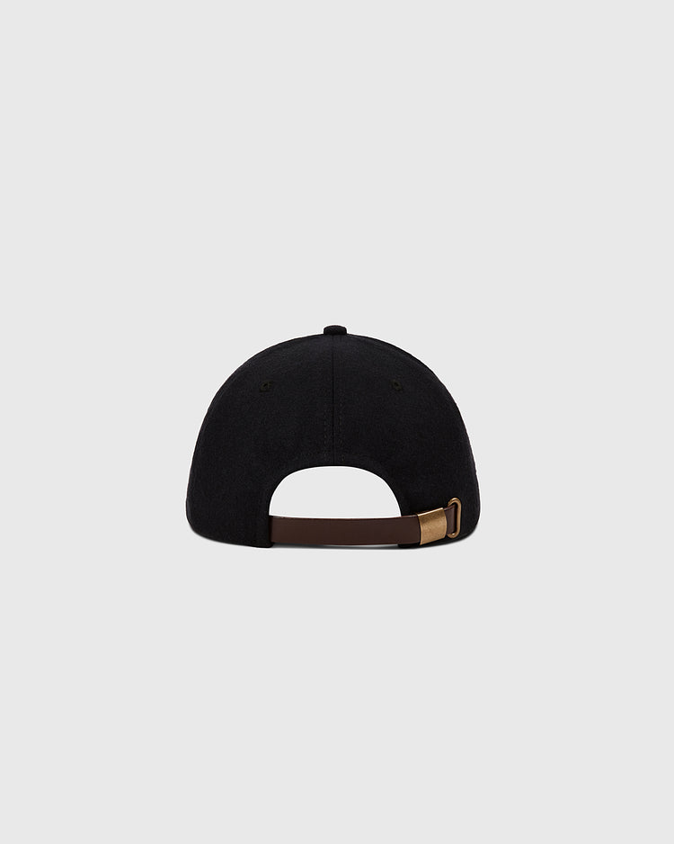 A black Muhammad Ali Vintage Inspired Wool Ballcap by Ebbets Field, shown from the back with a brown adjustable strap and brass buckle, evokes Thrilla in Manila spirit against a plain light gray background.
