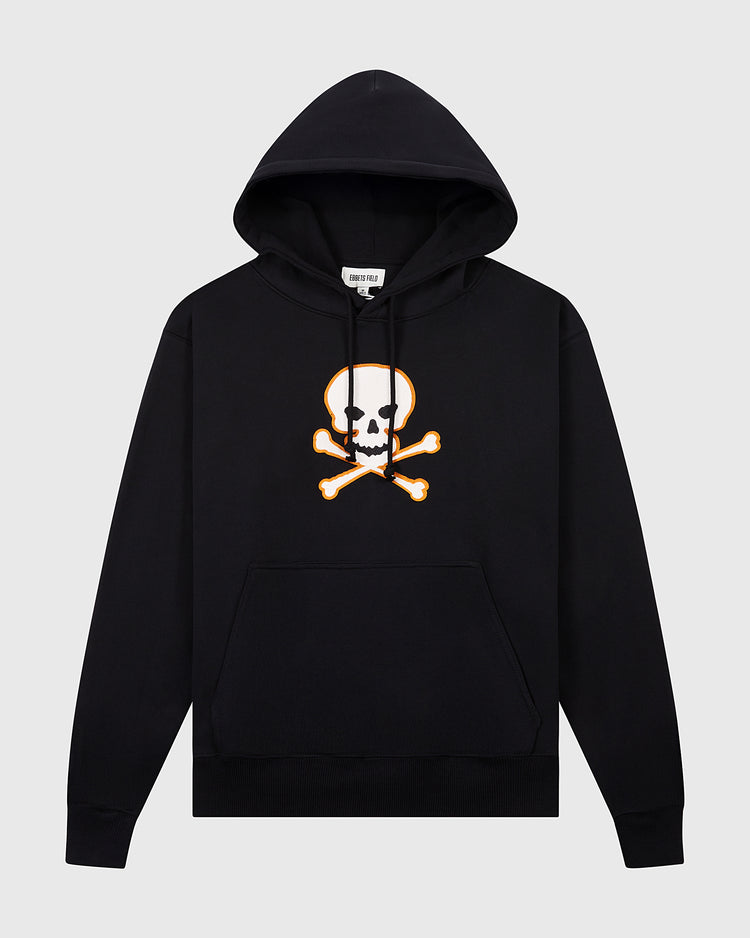 The Ebbets Field Sioux City Ghosts Double Felt Heavyweight Cotton Terry Pullover Hoodie is black with a white skull and crossbones graphic outlined in orange on the chest and a front kangaroo pocket, shown against a light gray background.