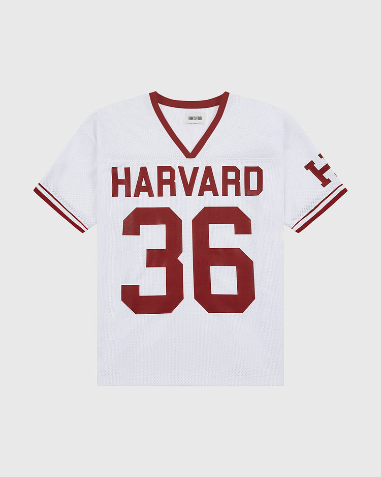 The Ebbets Field Harvard Vintage Mesh Football Jersey features white mesh with red trim, bold HARVARD and 36 in red on the front, a red H on the left sleeve, and classic football style. Made in the USA.