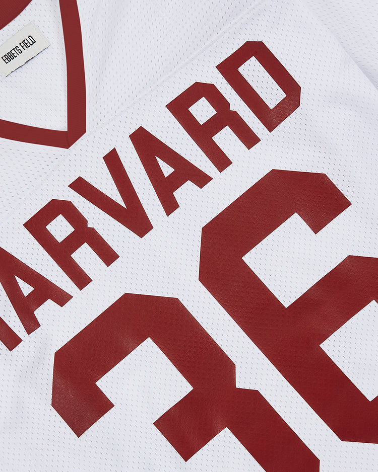 A close-up of the white Harvard Vintage Mesh Football Jersey by Ebbets Field, featuring HARVARD and number 36 in bold red, plus a CORNERS FIELD tag inside the collar for a classic throwback style.