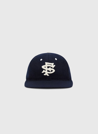 The EFF San Francisco Seals 1949 Authentic Wool Ballcap in navy features interlocking white embroidery on the front, echoing caps worn on post-war Japan tours, shown against a light gray background.