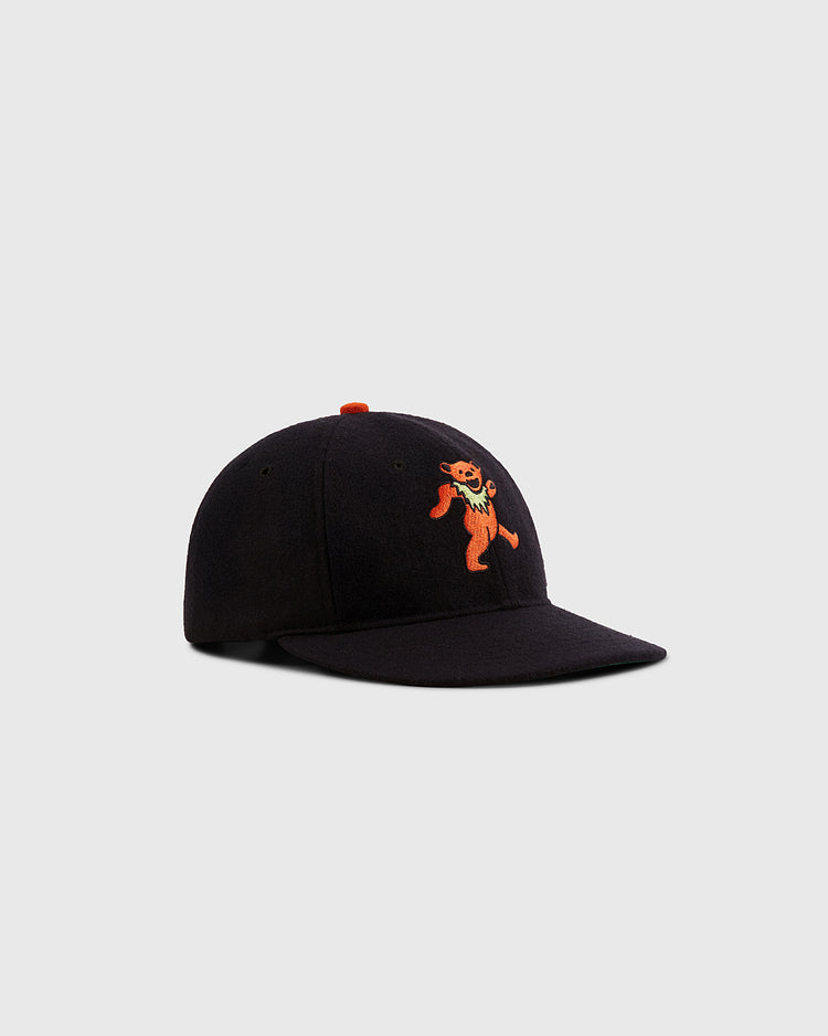 The Ebbets Field Grateful Dead Dancing Bear Wool Ballcap in black features an orange dancing bear logo embroidered on the front, displayed against a plain light gray background.