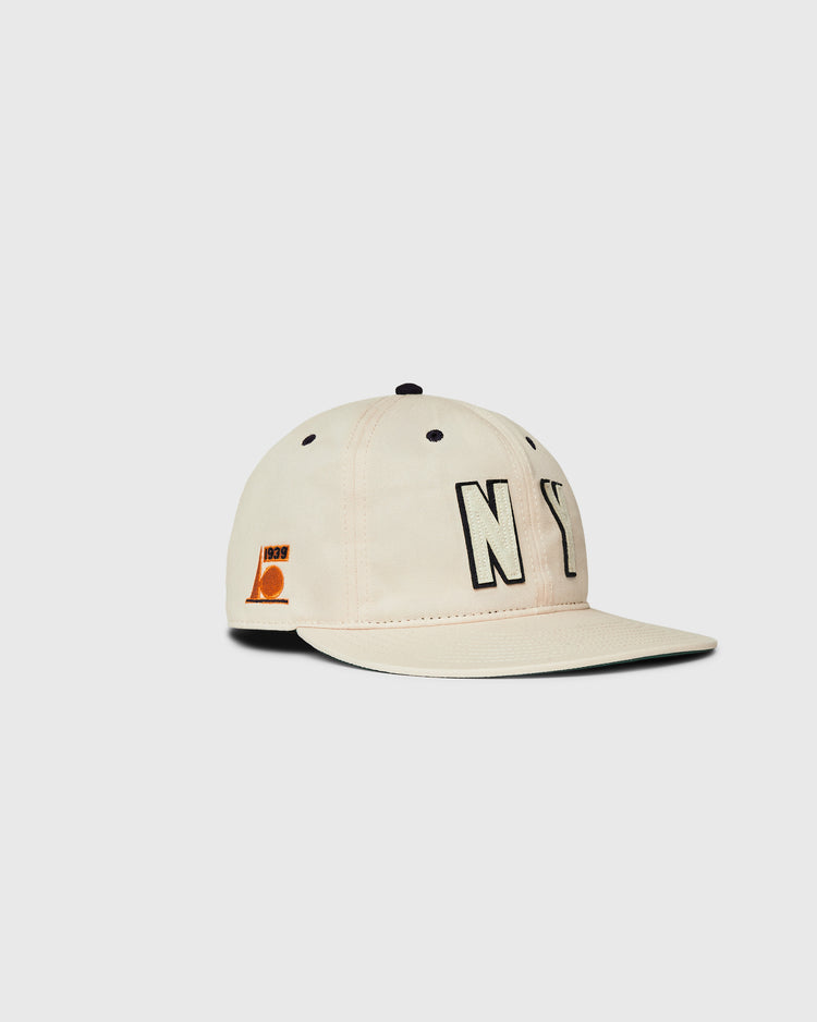 A beige Ebbets Field New York 1939 World's Fair Cotton Twill Ballcap with bold black NY letters on the front and a small orange 1993 patch on the side, shown against a plain white background.