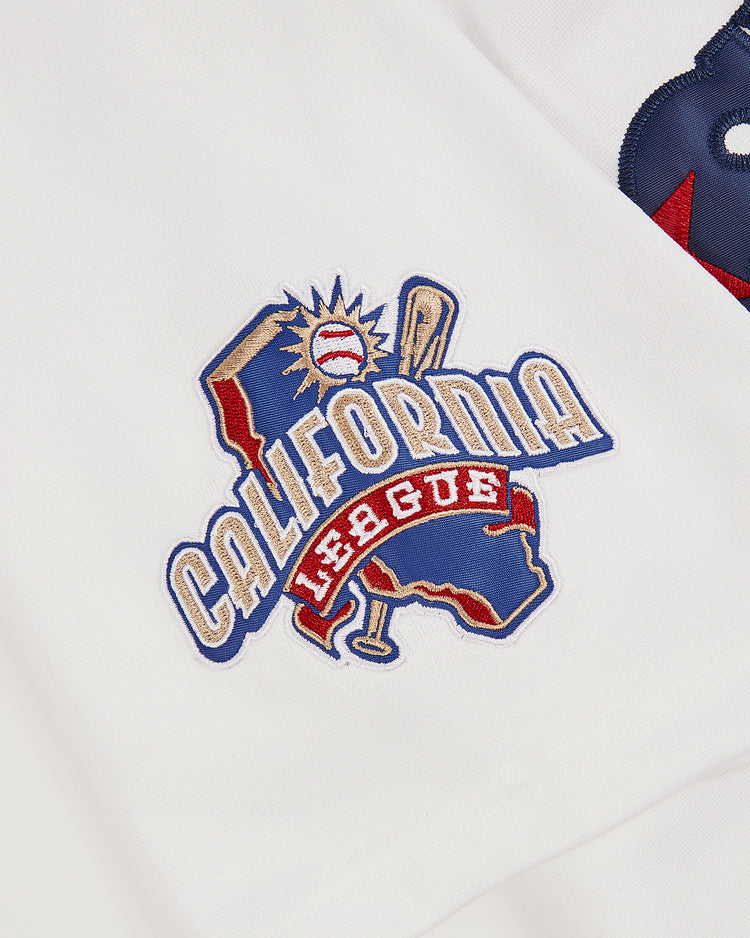 A close-up of the Ken Griffey Jr Bernardino Spirit Button Up Jersey by Ebbets Field, showcasing a white fabric with an embroidered California outline, baseball, bat, and 