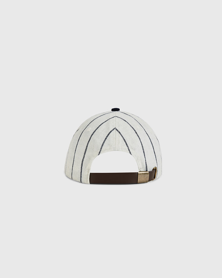 Back view of the Ebbets Field US Tour Of Japan 1934 Authentic Wool Ballcap in white with thin navy stripes, a dark brown adjustable strap, and brass-colored buckle. Inspired by the classic 1934 design. Set against a plain light gray background.