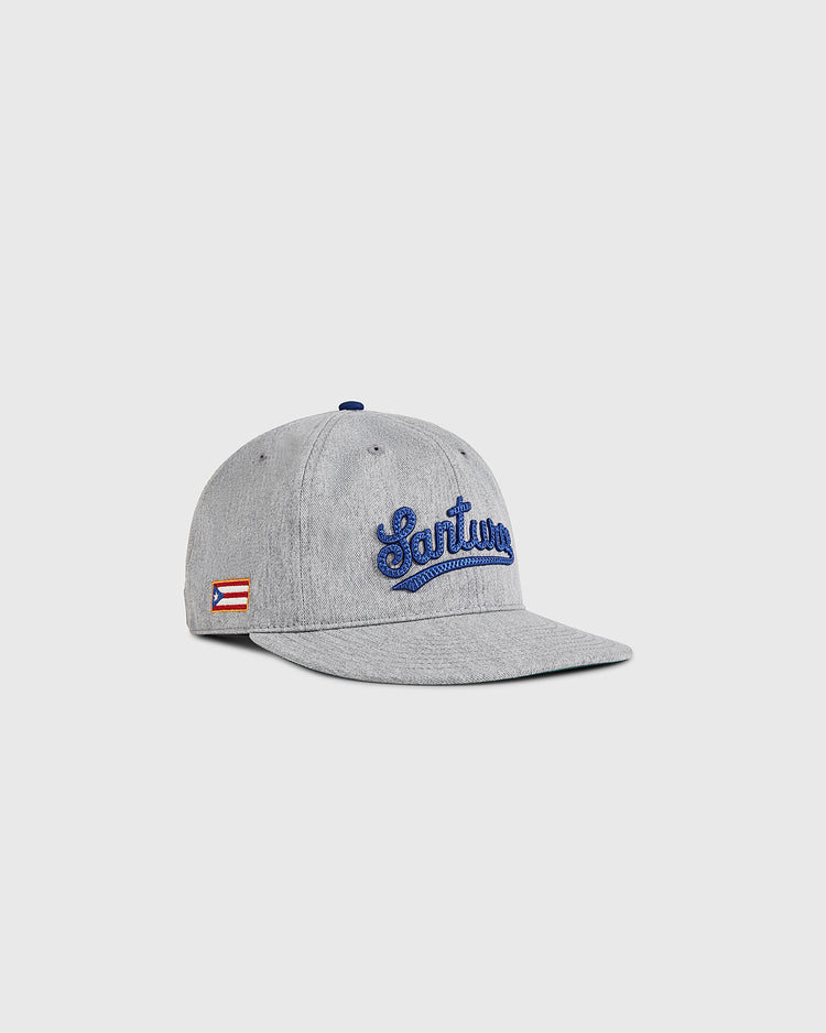 The Ebbets Field Santurce Cangrejeros 1939 Cotton Twill Ballcap features “Santurce” embroidered in blue and a Puerto Rican flag patch, shown on a plain light background.