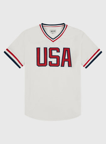 The Ebbets Field USA National Team Mesh V-Neck Jersey is a white mesh baseball jersey with bold red and blue 