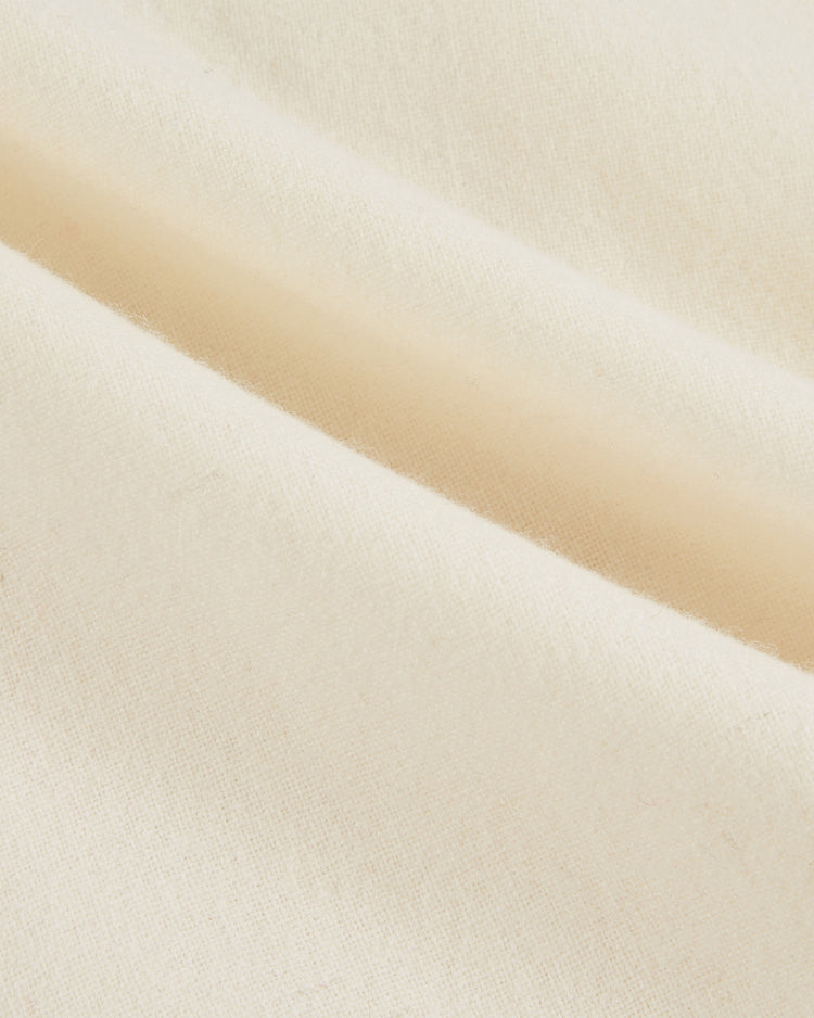 Close-up of soft, cream-colored wool from the Ebbets Field Team USA 1936 Authentic Baseball Jersey, showing a smooth texture and visible folds that evoke a vintage jersey’s gentle drape and subtle weave pattern.