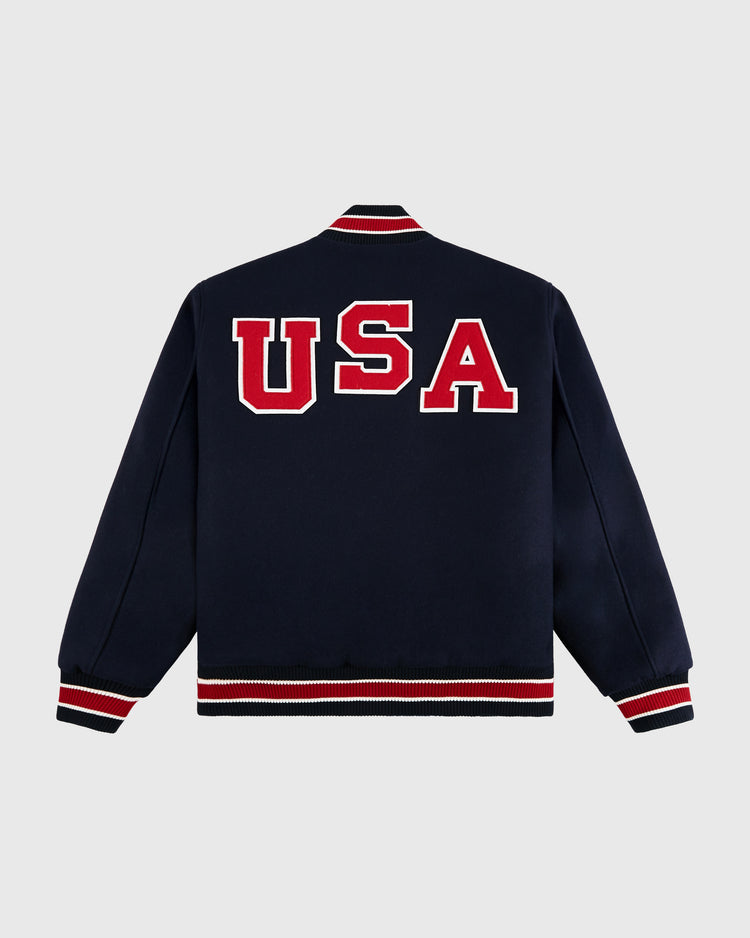 The Ebbets Field Team USA 1960 Miracle On Ice All-Wool Varsity Jacket features a blue design with vintage red felt lettering.