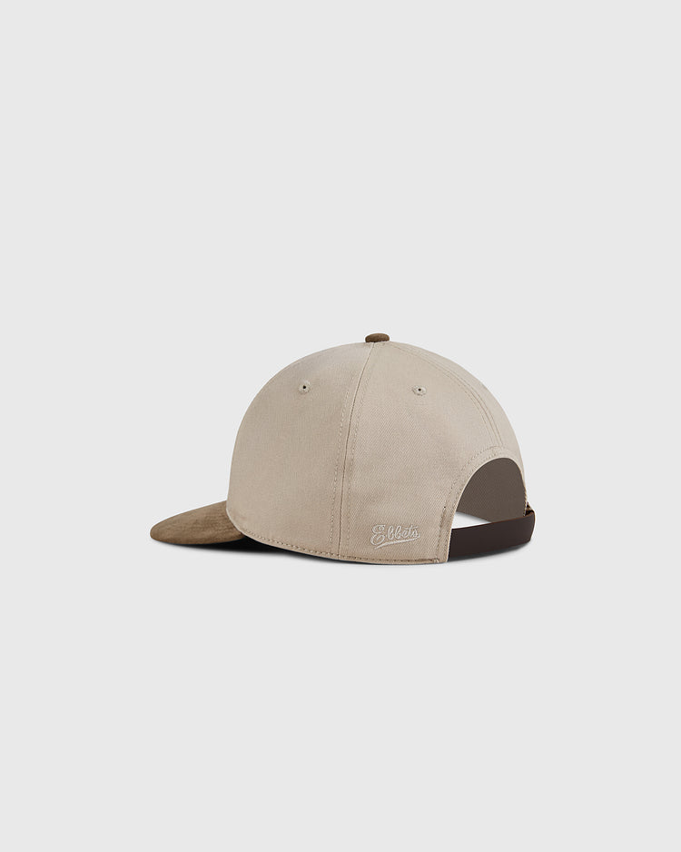 A Kansas City Monarchs 1945 Cotton Twill Suede Ballcap by Ebbets Field, beige with a brown suede brim, shown from the back. It features an adjustable strap and small embroidered logo above the opening. Plain white background.