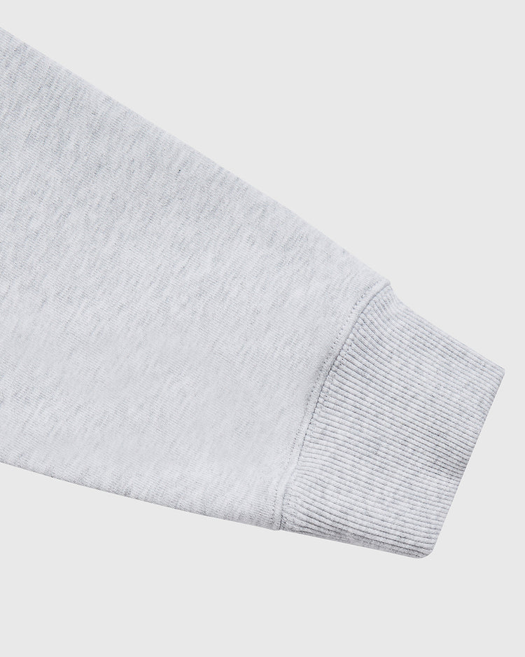 A close-up of the Ebbets Field Puerto Rico 1972 National Team Heavyweight Cotton Terry Pullover Hoodie sleeve, highlighting the ribbed cuff and soft light grey fabric texture against a plain white background.