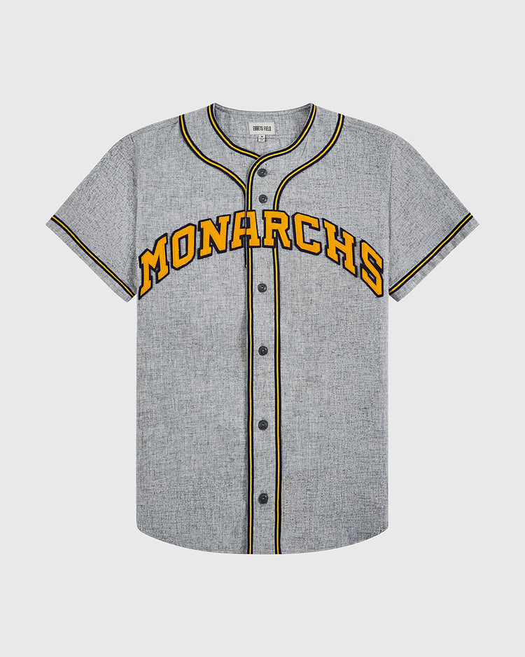 The EFF Kansas City Monarchs 1945 Authentic Wool Road Baseball Jersey features gray wool, black and yellow trim, black buttons, and bold yellow MONARCHS lettering with a black outline across the chest.