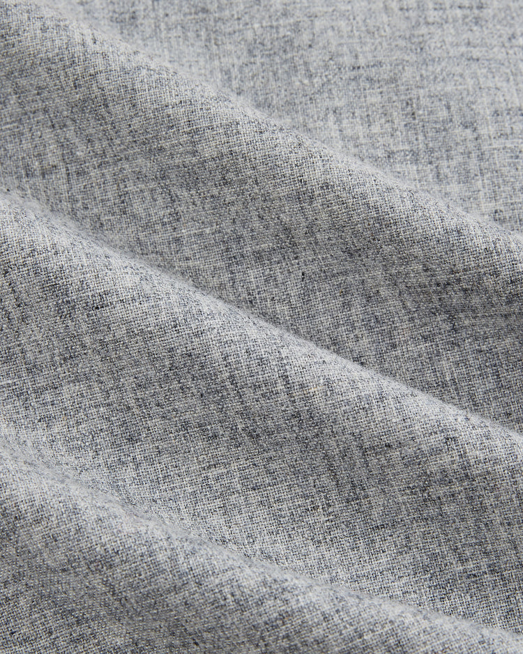Close-up of light gray, textured fabric with fine weave and gentle folds, inspired by the EFF Kansas City Monarchs 1945 Authentic Wool Road Baseball Jersey.