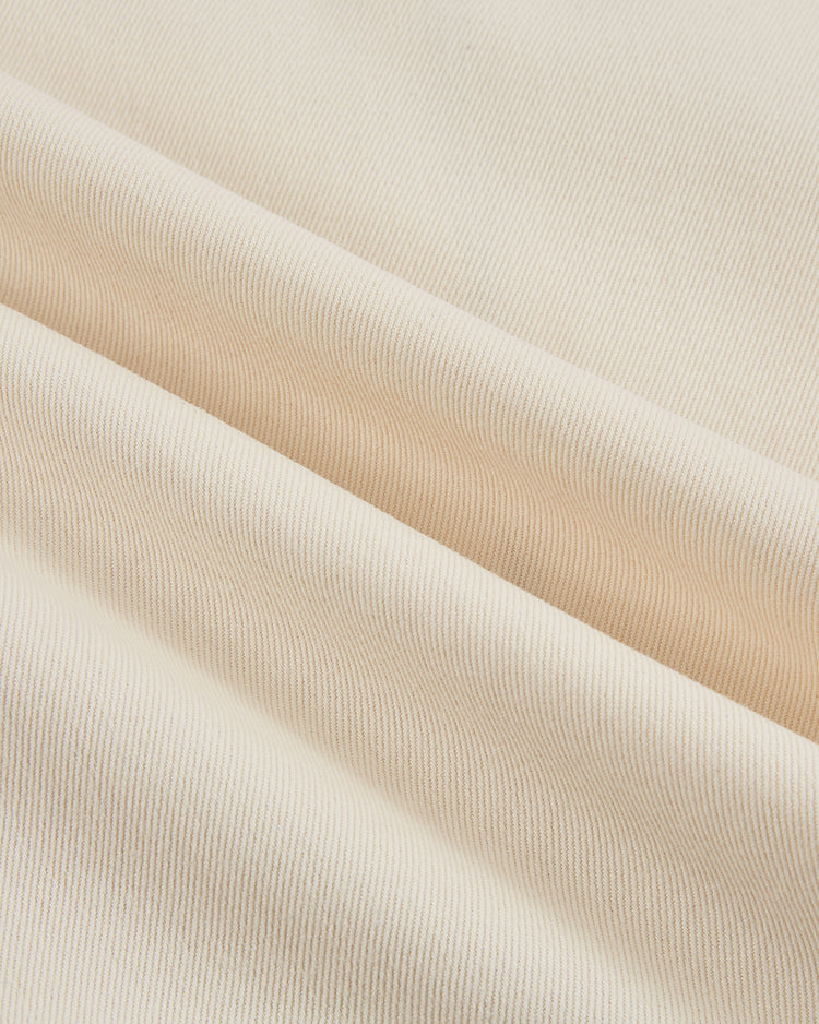 Close-up of cream-colored, ribbed cotton twill with soft folds and subtle shading—evoking the texture and look of the Ebbets Field Satchel Paige All-Stars 1933 Jersey.
