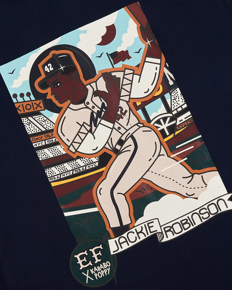 The Ebbets Field Karabo Poppy x Jackie Robinson Short Sleeve Graphic Tee features an illustrated Jackie Robinson mid-run in uniform #42, with a stadium background. Bold 