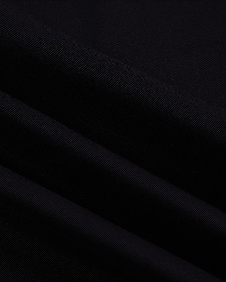 Close-up of black cotton twill fabric from the Ebbets Field New York Cubans Baseball Jersey, featuring soft folds, a smooth texture, and subtle shadows in the draped material.