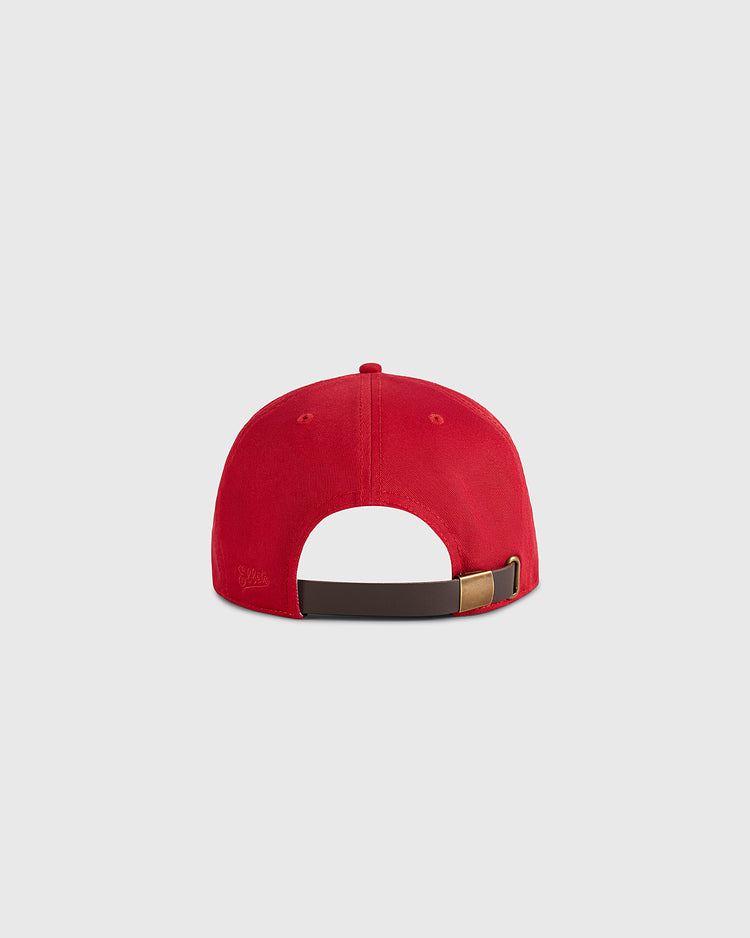 The Habana Leones Cotton Twill Ballcap by Ebbets Field is shown from the back, featuring red cotton twill, an adjustable brown strap with metal clasp, set against a plain light gray background.