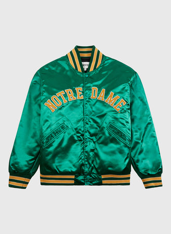 The Ebbets Field Notre Dame Satin Varsity Jacket features yellow “NOTRE DAME” embroidery, yellow and white striped trim, vintage styling, and two front flap pockets.