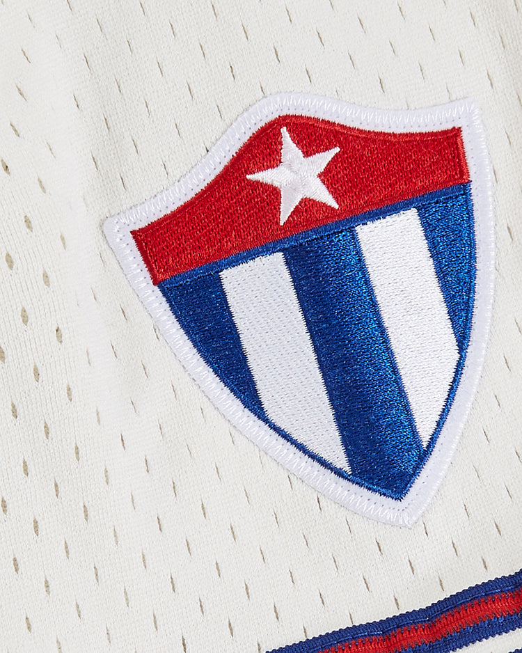 The Ebbets Field Havana Cubans Mesh Baseball Jersey features a white, blue, and red star shield patch sewn onto white mesh fabric, inspired by the vintage jerseys once worn by the Havana Cubans minor league team.