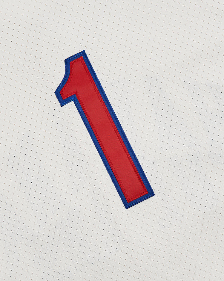 The Ebbets Field Havana Cubans Mesh Baseball Jersey features a red number one outlined in blue, stitched on white perforated fabric, echoing the iconic vintage style of the original team jersey.