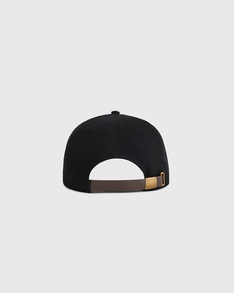 A black Guinness Extra Stout Patch Cotton Twill Ballcap by Ebbets Field, shown from the back with an adjustable brown strap and gold buckle against a light gray background, inspired by classic Ebbets Field style.