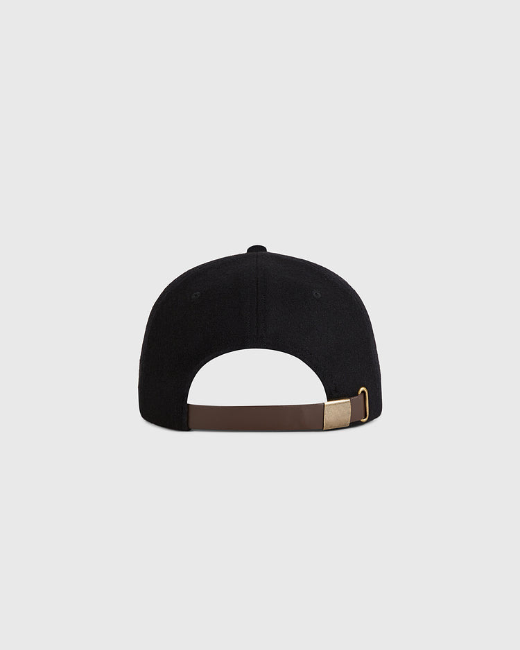 The Guinness Tortoise Authentic Wool Ballcap by Ebbets Field is shown from the back, featuring a brown adjustable strap with a brass buckle, set against a plain light gray background.
