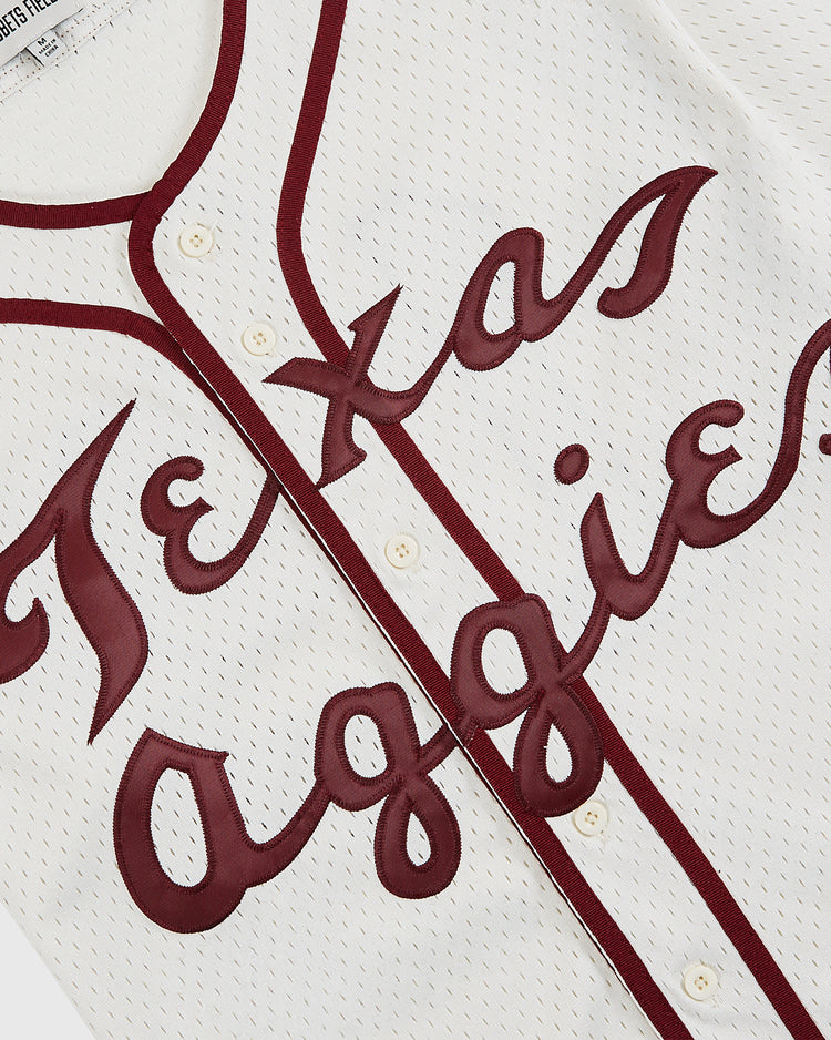 A close-up of the Ebbets Field Texas A&M University 1952 Mesh Baseball Jersey in white with maroon trim, featuring 