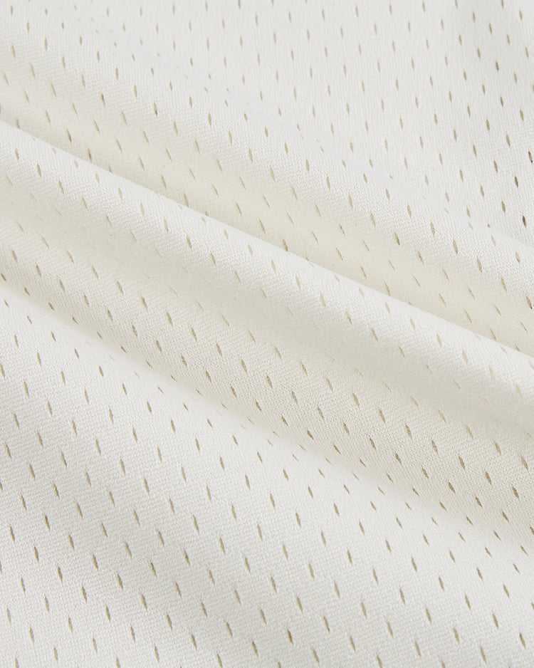 Close-up of the Ebbets Field Texas A&M University 1952 Mesh Baseball Jersey, featuring soft, breathable white fabric with small perforations and diagonal folds inspired by classic Aggies style.
