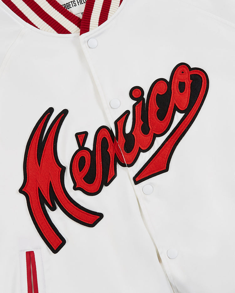 The Diablos Rojos del Mexico Satin Varsity Jacket by Ebbets Field is a white jacket with red and black trim, featuring bold, stylized 