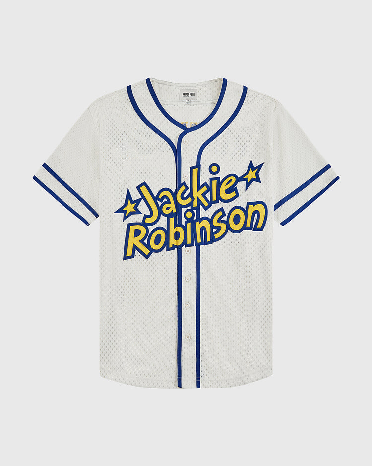 The Ebbets Field Jackie Robinson Comic Book Hero Mesh Baseball Jersey features bold Jackie Robinson lettering with star accents, white mesh fabric, and blue trim—honoring his legacy in breaking baseball’s color barrier.