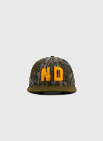 The Ebbets Field Mossy Oak x 1966 University of Notre Dame Ballcap features Bottomland camo and bold yellow ND embroidery, shown against a plain light gray background.